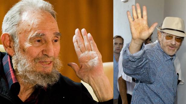 Ein Doppelporträt von Fidel Castro und Steven Spielberg, die beide winken.