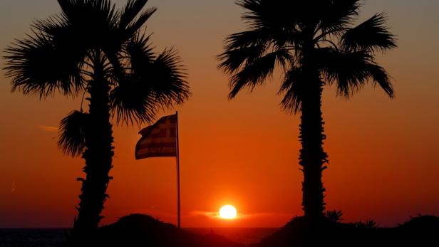 ReutersA Greek flag flutters as the sun sets framed by palm trees on the beach front of Olympia Riviera resort in the town of Killini, some 285 kms southwest of Athens May 31, 2012. Greeces sandy resorts, azure waters and ancient temples remain popular, b
