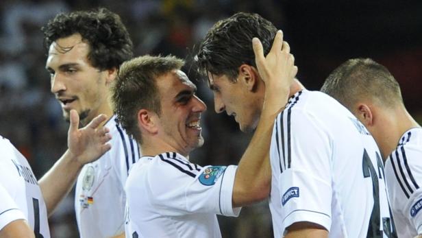 Philipp Lahm umarmt einen Mitspieler der deutschen Nationalmannschaft.
