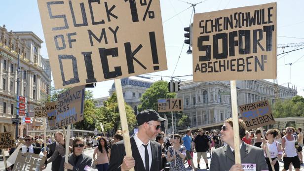 Eine Demonstration mit Protestschildern in einer städtischen Umgebung.
