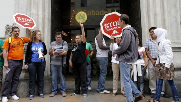 REUTERSMembers of the Mortgage Victims Platform (PAH) protest demanding dation in payment in front of a Banco Sabadell branch in Valencia September 27, 2012. The signs read: "Stop evins&#ns". TERUTERS/Heialis (SPAIN - Tags: BUSINESSNESS CIVIL UNRES