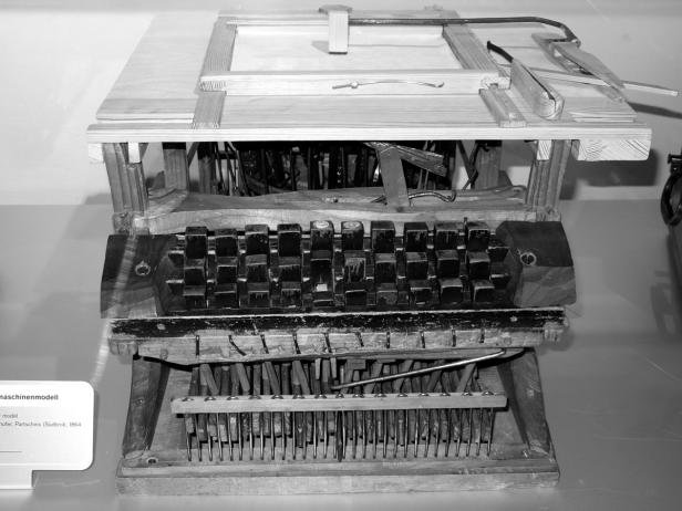 Ein komplexes, hölzernes Maschinenmodell mit Tasten und filigranen Mechanismen.