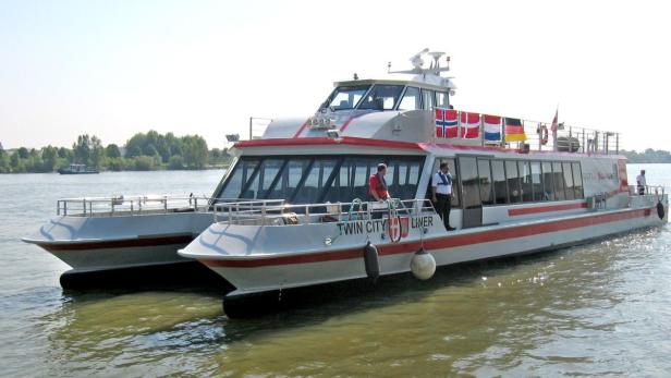 Ein Katamaran-Fahrgastschiff namens „Twin City Liner“ auf einem Fluss.