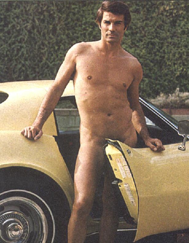 Ein Mann steht unbekleidet neben einem gelben Sportwagen.