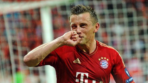 Ein Fußballspieler im roten Trikot des FC Bayern München jubelt mit geballter Faust.