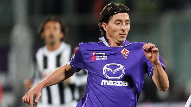 Ein Fußballspieler im lila Trikot der AC Florenz während eines Spiels.