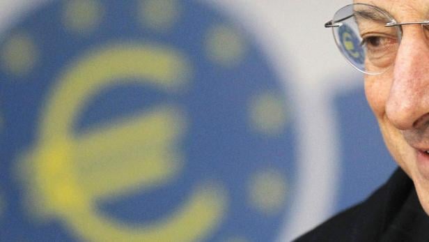 Ein Mann mit Brille vor dem Hintergrund des Euro-Symbols.