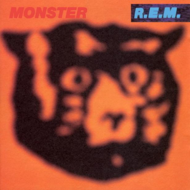 Das Cover des Albums „Monster“ von R.E.M. zeigt ein verschwommenes Monstergesicht auf orangefarbenem Hintergrund.