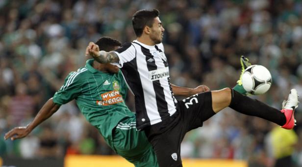 Zwei Fußballspieler kämpfen um den Ball während eines Spiels.