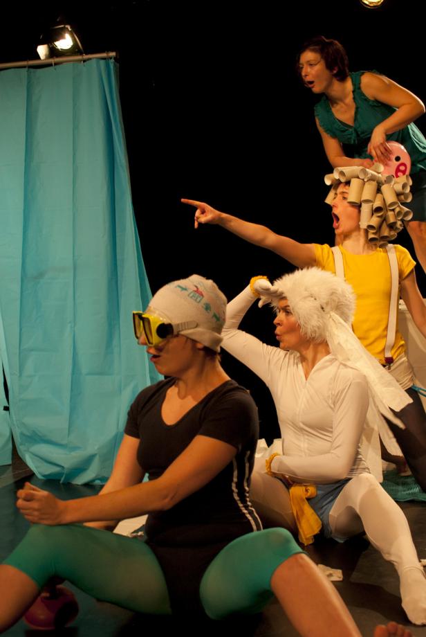 Eine Gruppe von Frauen in Kostümen tritt auf einer Bühne auf.