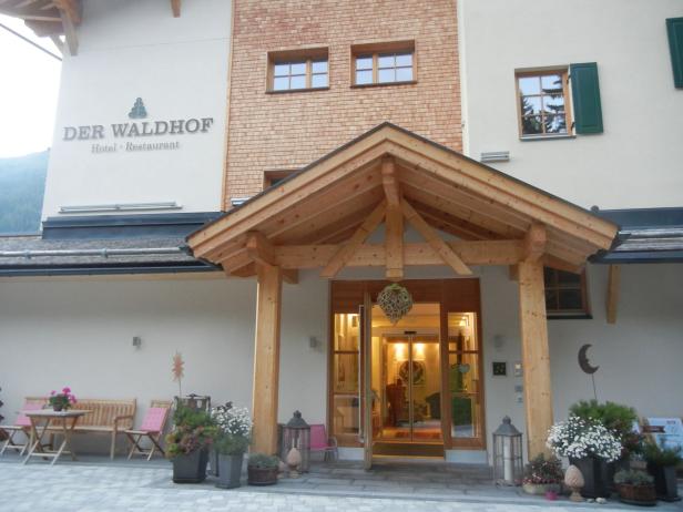 Der Eingangsbereich des „Waldhof Hotel-Restaurant“ mit Holzelementen und Dekorationen.