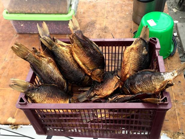 Geräucherte Fische liegen in einem Korb zum Verkauf.