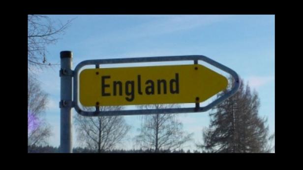 Ein gelbes Schild weist den Weg nach England.