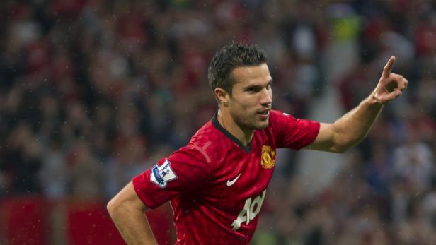 Robin van Persie im Trikot von Manchester United jubelt mit erhobenem Zeigefinger.