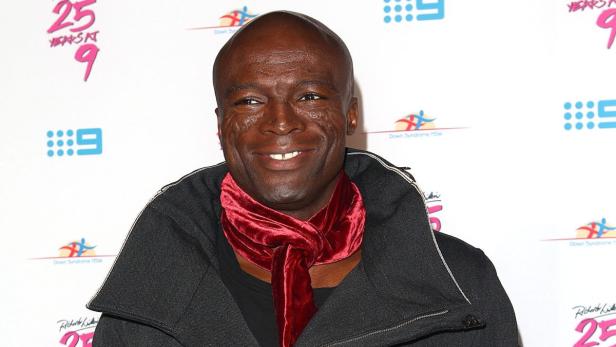 Der Sänger Seal mit einem roten Schal bei einer Veranstaltung.