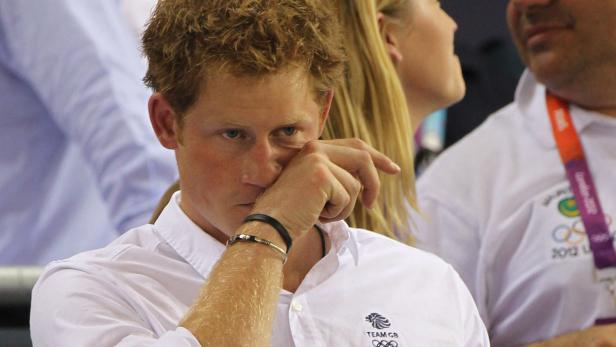 Prinz Harry wischt sich eine Träne aus dem Auge.