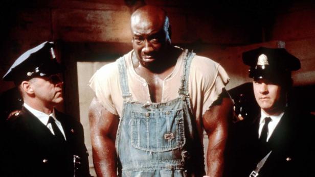 John Coffey, dargestellt von Michael Clarke Duncan, zwischen zwei Wärtern in „The Green Mile“.