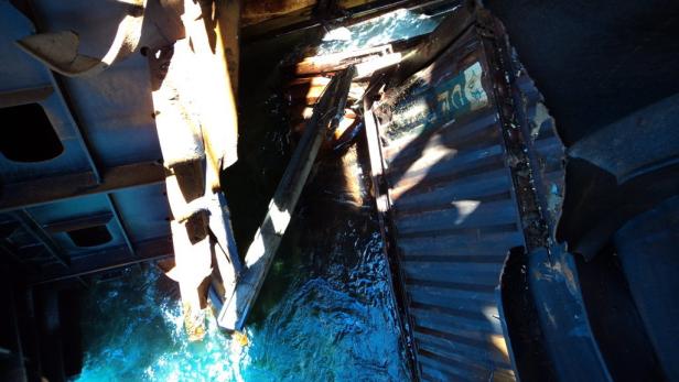 Das Innere eines beschädigten Schiffsrumpfs mit eindringendem Wasser.