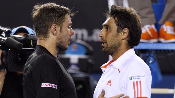 Zwei Tennisspieler stehen sich gegenüber und diskutieren.