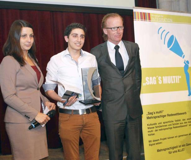 Drei Personen stehen bei der Preisverleihung des Wettbewerbs „Sag’s multi!“.