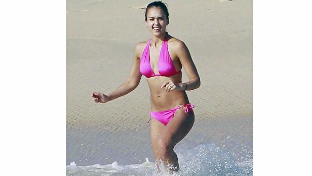 Jessica Alba läuft am Strand in einem pinkfarbenen Bikini.