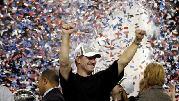 Ein Mann mit einer Kappe jubelt inmitten von Konfetti.