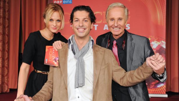 Drei Personen posieren für ein Foto bei einer Veranstaltung von „Dancing Stars“.
