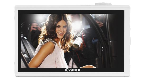 Eine Frau steigt aus einem Auto, umgeben von Fotografen mit Blitzlicht.