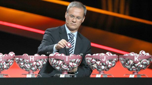Ein Mann zieht eine Kugel bei der Auslosung für die UEFA Europa League.