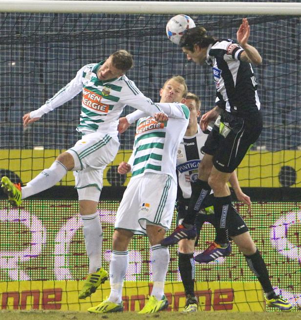 Fußballspieler kämpfen bei einem Spiel um den Ball.