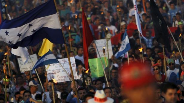 A demonstrator waves a Honduras' flag during a mar