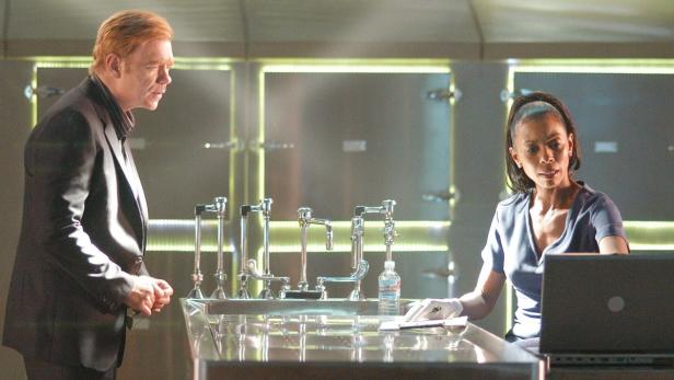 Zwei Personen stehen in einem Labor mit einem Laptop und einer Spüle.