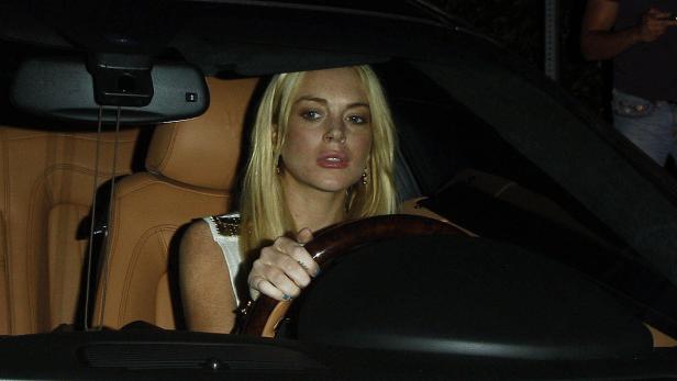 Lindsay Lohan sitzt am Steuer eines Autos.