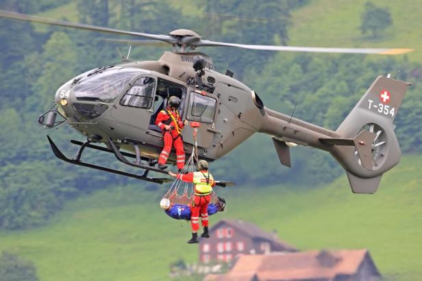 Ein Schweizer Rettungshelikopter birgt eine verletzte Person.