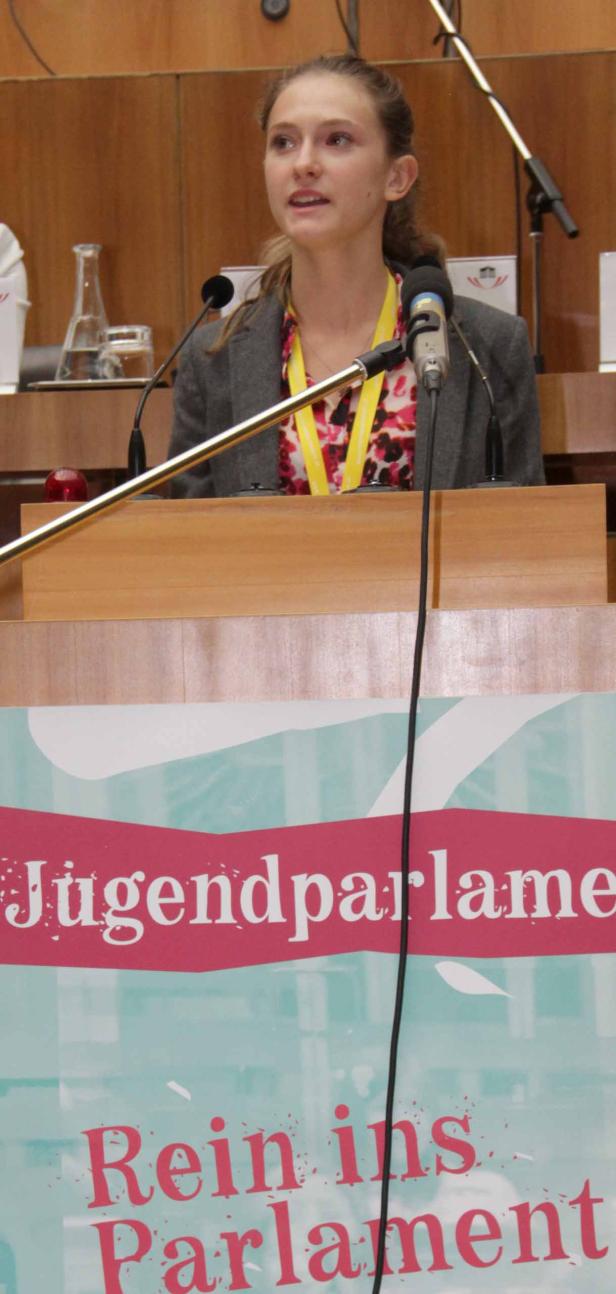 Eine junge Frau spricht am Rednerpult des Jugendparlaments.