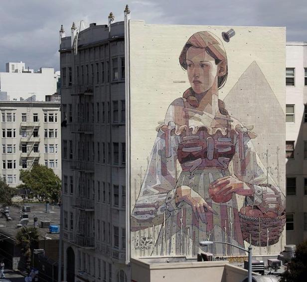 Ein Wandgemälde zeigt eine stilisierte Frau mit einem Korb voller Äpfel vor dem Hintergrund einer Stadtlandschaft.