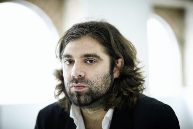 Porträt eines Mannes mit Bart und langen, gewellten Haaren.