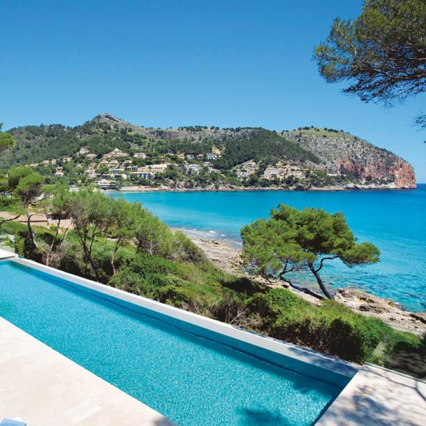 Ein langer Pool mit Blick auf eine malerische Küstenlandschaft.