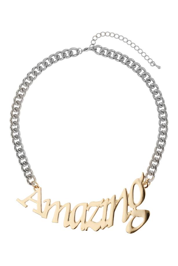 Eine silberne Halskette mit einem goldenen Anhänger, der das Wort „Amazing“ bildet.