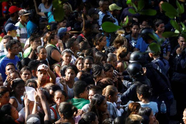 Relatives of inmates at the General Command of the Carabobo Police wait outside the prison in Valencia