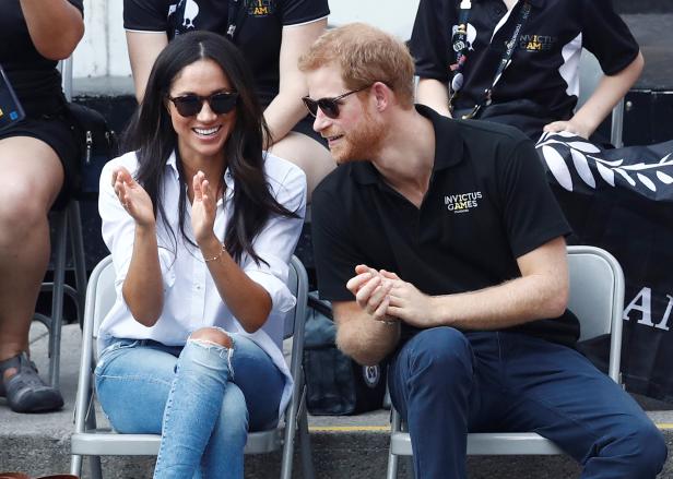 Britain's Prince Harry sits with girlfriend actress Markle to watch a wheelchair tennis event during the Invictus Games in Toronto