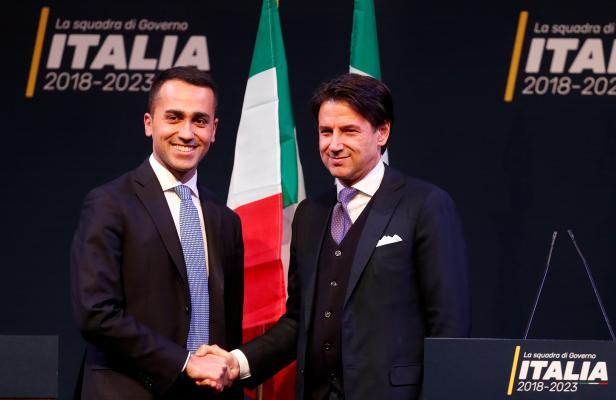 5-Star Movement leader Di Maio shakes hands with Giuseppe Conte, who would be Minister for Simplification of Public Administration with the Parliament in any 5-Star government, during the presentation of the would-be cabinet team, ahead of election in Rome