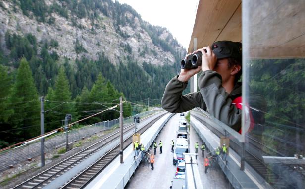 A soldier of the Austrian Federal Armed Forces observes a track during tri-national border routine check near Gries am Brenner pass