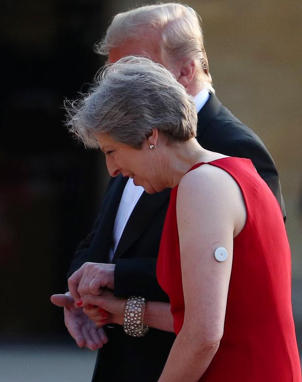 British Prime Minister Theresa May and U.S. President Donald Trump climb the steps to the entrance of Blenheim Palace, where they are attending a dinner with specially invited guests and business leaders, near Oxford