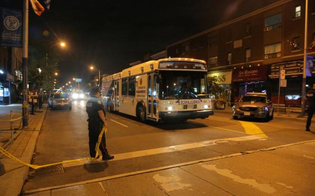 A paramedic bus leaves the area cordoned off by the police near the scene of a mass shooting in Toronto