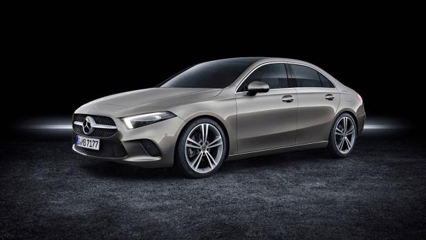 Eine graue Mercedes-Benz A-Klasse Limousine vor einem schwarzen Hintergrund.