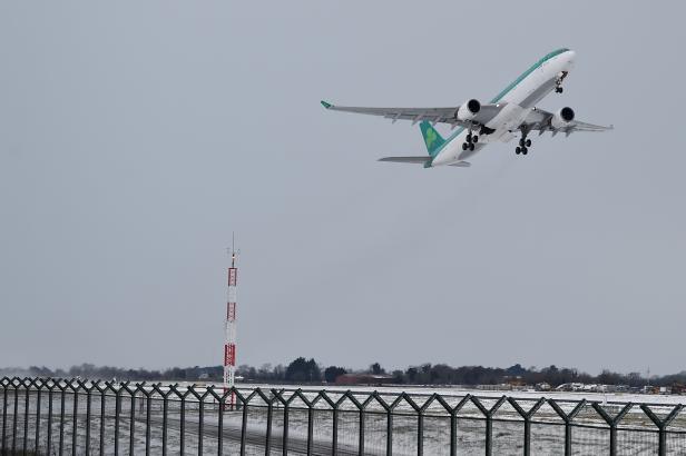 An Aer Lingus plane takes off at Dublin airport during a break in the snow showers in Dublin