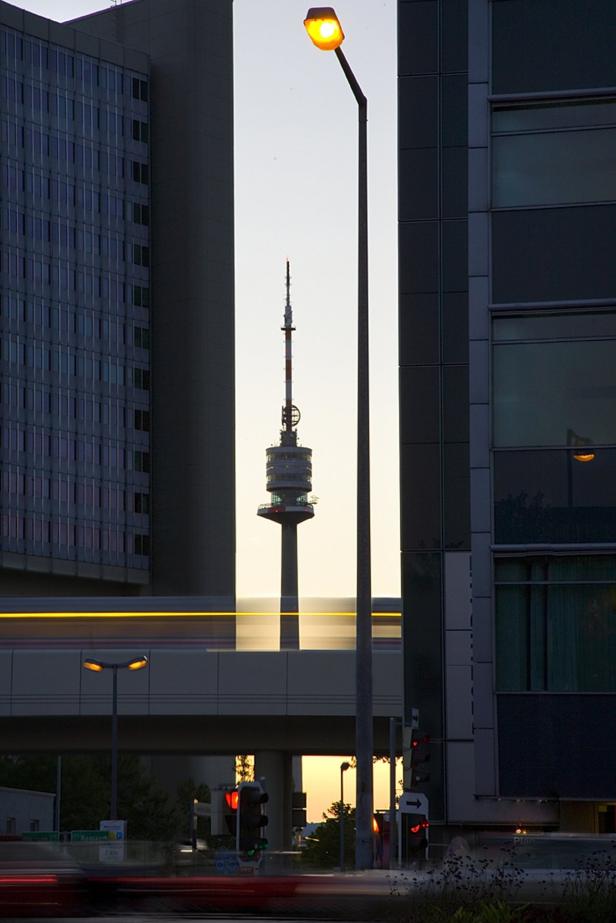 Neu erschienen: Ein Buch über den Wiener Donauturm Der Donauturm ragt zwischen modernen Gebäuden in Wien in den Himmel.