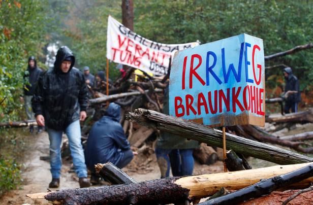 People build a barricade as they protest against German utility and power supplier RWE near Kerpen-Buir