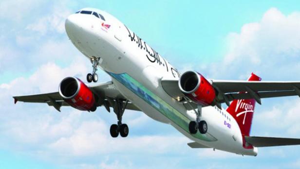 Ein Flugzeug von Virgin Atlantic startet vor blauem Himmel.